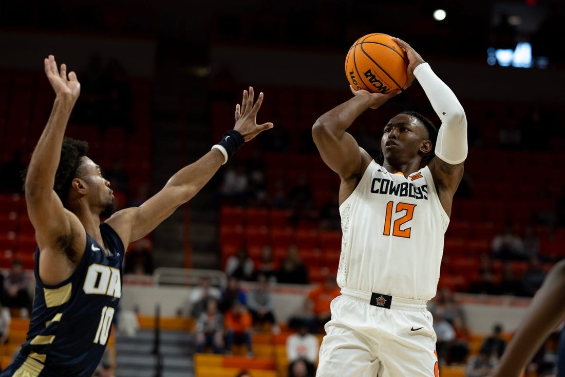 Dec 17, 2023; Stillwater, Okla, USA ; Oklahoma State Cowboys guard Javon Small (12) shoots over Oral Roberts Golden Eagles guard Issac McBride (10) in the first half of an NCAA basketball game at Gallagher Iba arena. Mandatory Credit: Mitch Alcala-The Oklahoman