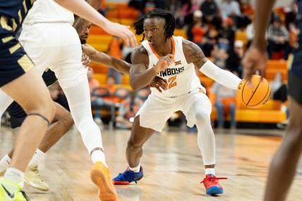 Dec 17, 2023; Stillwater, Okla, USA ; Oklahoma State Cowboys guard Javon Small (12) brings the ball up the court in the first half of an NCAA basketball game against the Oral Roberts Golden Eagles at Gallagher Iba arena. Mandatory Credit: Mitch Alcala-The Oklahoman