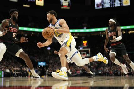 Dec 17, 2023; Portland, Oregon, USA; Golden State Warriors point guard Stephen Curry (30) dribbles the ball as Portland Trail Blazers center Deandre Anton (2) defends during the first half at Moda Center. Mandatory Credit: Soobum Im-USA TODAY Sports