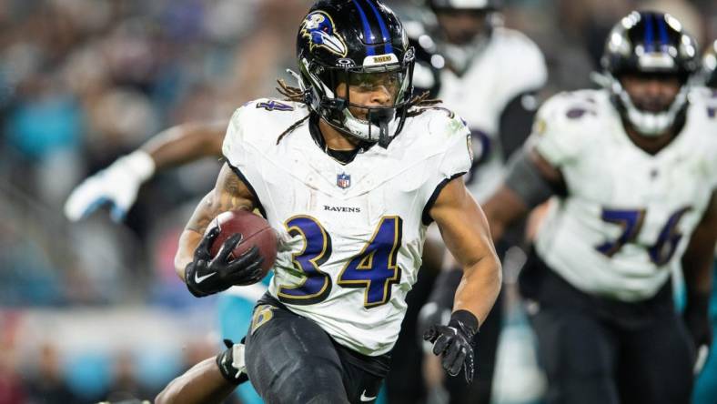 Dec 17, 2023; Jacksonville, Florida, USA; Baltimore Ravens running back Keaton Mitchell (34) runs the ball against the Jacksonville Jaguars in the fourth quarter at EverBank Stadium. Mandatory Credit: Jeremy Reper-USA TODAY Sports