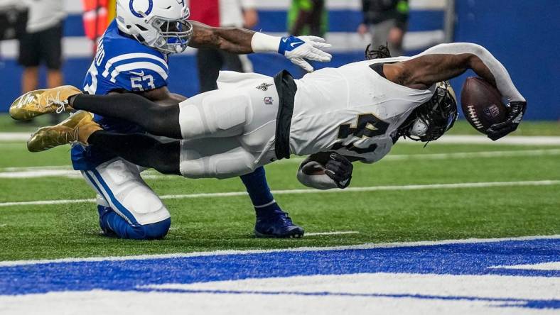 New Orleans Saints running back Alvin Kamara (41) dives for a touchdown, under defensive pressure from Indianapolis Colts linebacker Shaquille Leonard (53), on Sunday, Oct. 29, 2023, at Lucas Oil Stadium in Indianapolis.