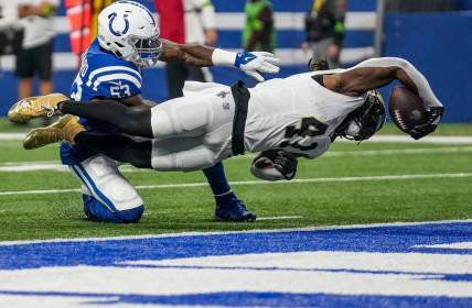 New Orleans Saints running back Alvin Kamara (41) dives for a touchdown, under defensive pressure from Indianapolis Colts linebacker Shaquille Leonard (53), on Sunday, Oct. 29, 2023, at Lucas Oil Stadium in Indianapolis.