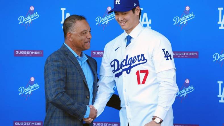 Dec 14, 2023; Los Angeles, CA, USA; Los Angeles Dodgers designated hitter Shohei Ohtani (17) shakes hands with manager Dave Roberts at press conference at Dodger Stadium. Mandatory Credit: Kirby Lee-USA TODAY Sports