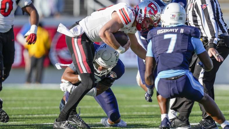 Dec 18, 2023; Charlotte, NC, USA; Western Kentucky Hilltoppers quarterback Caden Veltkamp (10) runs the ball against the Old Dominion Monarchs during the first quarter at Charlotte 49ers' Jerry Richardson Stadium. Mandatory Credit: Jim Dedmon-USA TODAY Sports