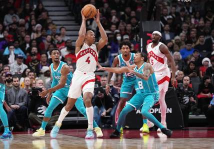 Dec 18, 2023; Toronto, Ontario, CAN; Toronto Raptors forward Scottie Barnes (4) controls the ball as Charlotte Hornets guard Nick Smith Jr. (8) tries to defend during the fourth quarter at Scotiabank Arena. Mandatory Credit: Nick Turchiaro-USA TODAY Sports