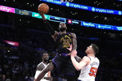 Dec 18, 2023; Los Angeles, California, USA; Los Angeles Lakers forward LeBron James (23) shoots the ball against New York Knicks center Isaiah Hartenstein (55) in the second half at Crypto.com Arena. Mandatory Credit: Kirby Lee-USA TODAY Sports