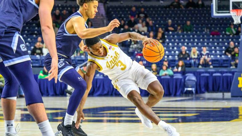 Dec 19, 2023; South Bend, Indiana, USA; Notre Dame Fighting Irish guard Markus Burton (3) loses his footing as Citadel Bulldogs guard Elijah Morgan (4) defends in the first half at the Purcell Pavilion. Mandatory Credit: Matt Cashore-USA TODAY Sports