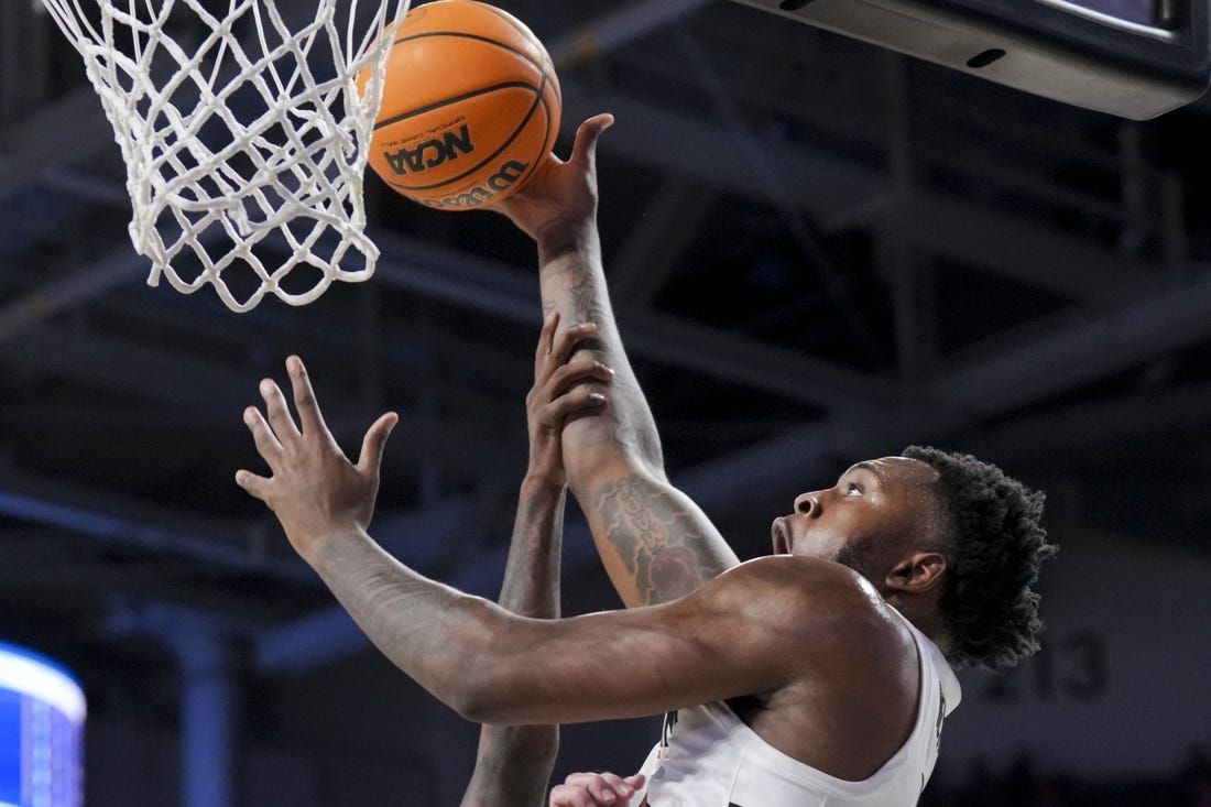 Dec 19, 2023; Cincinnati, Ohio, USA; Cincinnati Bearcats forward Jamille Reynolds (13) attempts a dunk as he is fouled by Merrimack Warriors guard Devon Savage (5) in the first half at Fifth Third Arena. Mandatory Credit: Aaron Doster-USA TODAY Sports