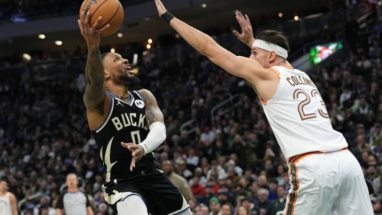 Dec 19, 2023; Milwaukee, Wisconsin, USA;  Milwaukee Bucks guard Damian Lillard (0) shoots around San Antonio Spurs center Zach Collins (23) during the first quarter at Fiserv Forum. Mandatory Credit: Jeff Hanisch-USA TODAY Sports