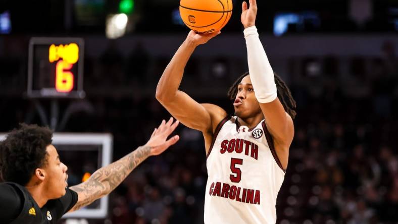 Dec 19, 2023; Columbia, South Carolina, USA; South Carolina Gamecocks guard Meechie Johnson (5) shoots over Winthrop Eagles guard Kasen Harrison (11) in the first half at Colonial Life Arena. Mandatory Credit: Jeff Blake-USA TODAY Sports