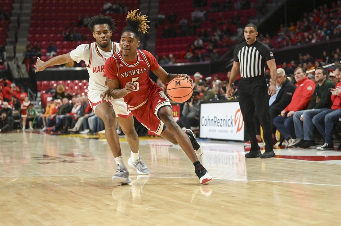 Dec 19, 2023; College Park, Maryland, USA;  Nicholls State Colonels forward Diante Smith (5) dribble by Maryland Terrapins guard Jahari Long (2) during the first half at Xfinity Center. Mandatory Credit: Tommy Gilligan-USA TODAY Sports