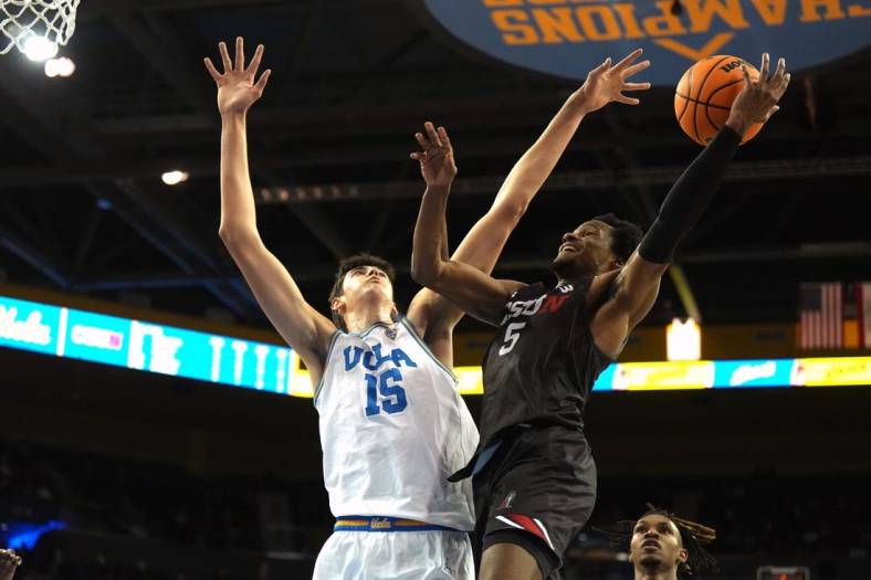 Dec 19, 2023; Los Angeles, California, USA; Cal State Northridge Matadors guard Gianni Hunt (5) shoots against UCLA Bruins center Aday Mara (15) in the first half at Pauley Pavilion presented by Wescom. Mandatory Credit: Kirby Lee-USA TODAY Sports