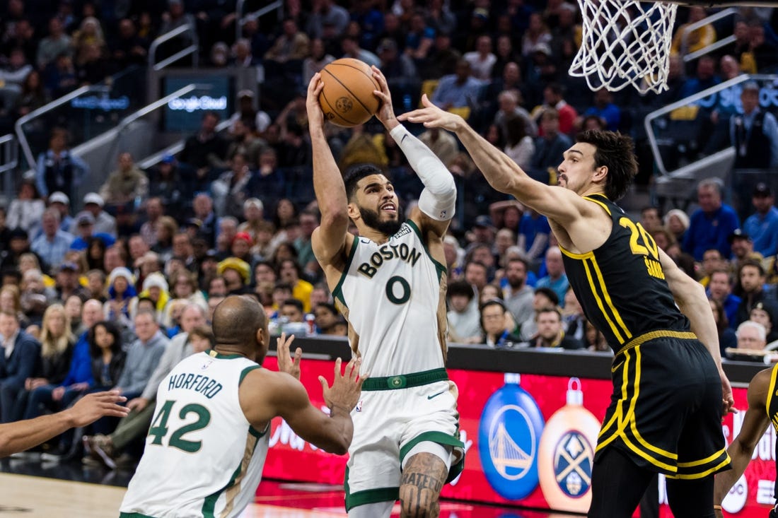 Dec 19, 2023; San Francisco, California, USA; Golden State Warriors forward Dario Saric (20) defends Boston Celtics forward Jayson Tatum (0) during the second half at Chase Center. Mandatory Credit: John Hefti-USA TODAY Sports