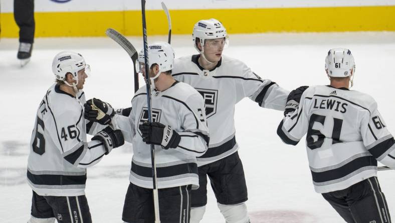 Dec 19, 2023; San Jose, California, USA; Los Angeles Kings center Trevor Lewis (61), center Blake Lizotte (46), defenseman Jacob Moverare (43) and defenseman Matt Roy (3) celebrate after a goal during the third period against the San Jose Sharks at SAP Center at San Jose. Mandatory Credit: Neville E. Guard-USA TODAY Sports