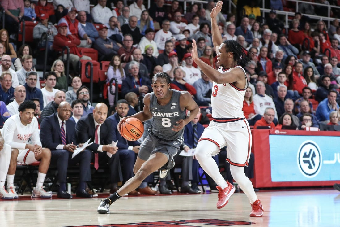 Dec 20, 2023; Queens, New York, USA; Xavier Musketeers guard Quincy Olivari (8) looks to drive past St. John's Red Storm guard Jordan Dingle (3) in the first half at Carnesecca Arena. Mandatory Credit: Wendell Cruz-USA TODAY Sports