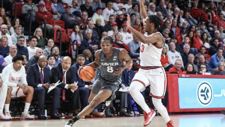 Dec 20, 2023; Queens, New York, USA; Xavier Musketeers guard Quincy Olivari (8) looks to drive past St. John's Red Storm guard Jordan Dingle (3) in the first half at Carnesecca Arena. Mandatory Credit: Wendell Cruz-USA TODAY Sports