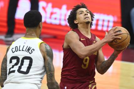 Dec 20, 2023; Cleveland, Ohio, USA; Cleveland Cavaliers guard Craig Porter (9) drives to the basket as Utah Jazz forward John Collins (20) defends in the second quarter at Rocket Mortgage FieldHouse. Mandatory Credit: David Richard-USA TODAY Sports
