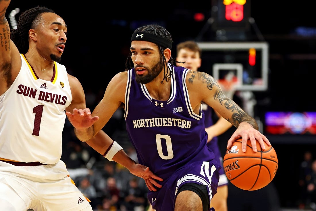 Dec 20, 2023; Phoenix, Arizona, USA; Northwestern Wildcats guard Boo Buie (0) drives to the basket against Arizona State Sun Devils guard Frankie Collins (1) during the first half during the Hall of Series at Footprint Center. Mandatory Credit: Mark J. Rebilas-USA TODAY Sports