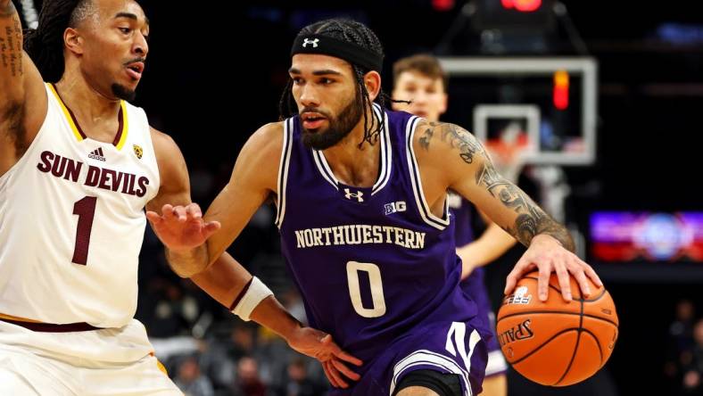 Dec 20, 2023; Phoenix, Arizona, USA; Northwestern Wildcats guard Boo Buie (0) drives to the basket against Arizona State Sun Devils guard Frankie Collins (1) during the first half during the Hall of Series at Footprint Center. Mandatory Credit: Mark J. Rebilas-USA TODAY Sports