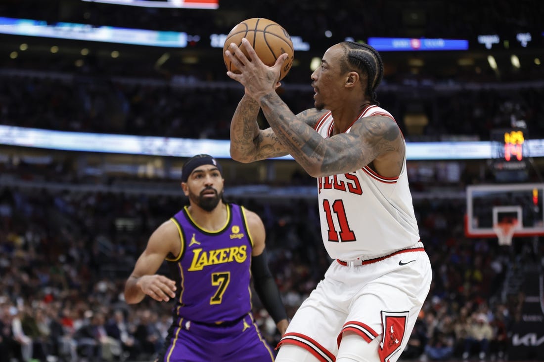 Dec 20, 2023; Chicago, Illinois, USA; Chicago Bulls forward DeMar DeRozan (11) shoots against Los Angeles Lakers guard Gabe Vincent (7) during the first half at United Center. Mandatory Credit: Kamil Krzaczynski-USA TODAY Sports