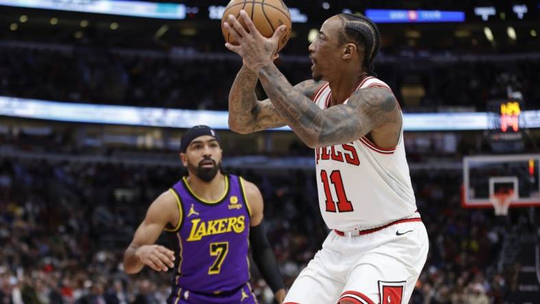 Dec 20, 2023; Chicago, Illinois, USA; Chicago Bulls forward DeMar DeRozan (11) shoots against Los Angeles Lakers guard Gabe Vincent (7) during the first half at United Center. Mandatory Credit: Kamil Krzaczynski-USA TODAY Sports