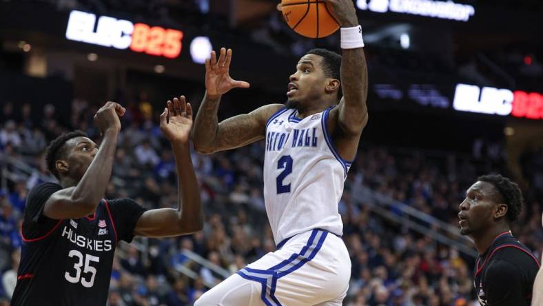 Dec 20, 2023; Newark, New Jersey, USA; Seton Hall Pirates guard Al-Amir Dawes (2) drives to the basket as Connecticut Huskies forward Samson Johnson (35) defends during the second half at Prudential Center. Mandatory Credit: Vincent Carchietta-USA TODAY Sports