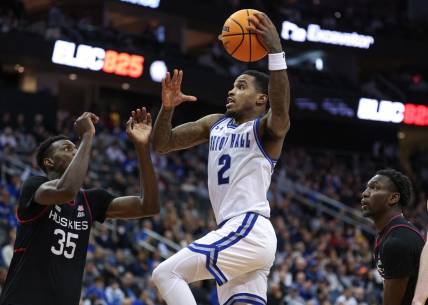 Dec 20, 2023; Newark, New Jersey, USA; Seton Hall Pirates guard Al-Amir Dawes (2) drives to the basket as Connecticut Huskies forward Samson Johnson (35) defends during the second half at Prudential Center. Mandatory Credit: Vincent Carchietta-USA TODAY Sports