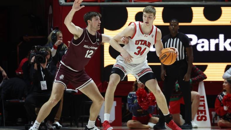 Dec 20, 2023; Salt Lake City, Utah, USA; Utah Utes center Lawson Lovering (34) posts up against Bellarmine Knights forward Langdon Hatton (12) during the first half at Jon M. Huntsman Center. Mandatory Credit: Rob Gray-USA TODAY Sports