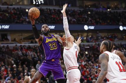 Dec 20, 2023; Chicago, Illinois, USA; Los Angeles Lakers forward LeBron James (23) goes to the basket against Chicago Bulls center Nikola Vucevic (9) during the second half at United Center. Mandatory Credit: Kamil Krzaczynski-USA TODAY Sports