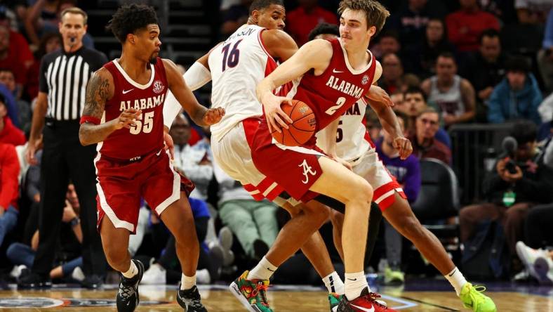 Dec 20, 2023; Phoenix, Arizona, USA; Alabama Crimson Tide forward Grant Nelson (2) handles the ball against Arizona Wildcats forward Keshad Johnson (16) during the second half in the Hall of Fame Series at Footprint Center. Mandatory Credit: Mark J. Rebilas-USA TODAY Sports