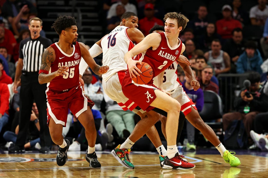 Dec 20, 2023; Phoenix, Arizona, USA; Alabama Crimson Tide forward Grant Nelson (2) handles the ball against Arizona Wildcats forward Keshad Johnson (16) during the second half in the Hall of Fame Series at Footprint Center. Mandatory Credit: Mark J. Rebilas-USA TODAY Sports