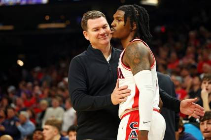 Dec 20, 2023; Phoenix, Arizona, USA; Arizona Wildcats head coach Tommy Lloyd talks to guard Caleb Love (2) during the second half of the game against the Alabama Crimson Tide in the Hall of Fame Series at Footprint Center. Mandatory Credit: Mark J. Rebilas-USA TODAY Sports