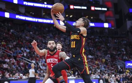 Dec 20, 2023; Houston, Texas, USA; Atlanta Hawks guard Trae Young (11) drives with the ball on a fast break as Houston Rockets guard Fred VanVleet (5) defends during the fourth quarter at Toyota Center. Mandatory Credit: Troy Taormina-USA TODAY Sports
