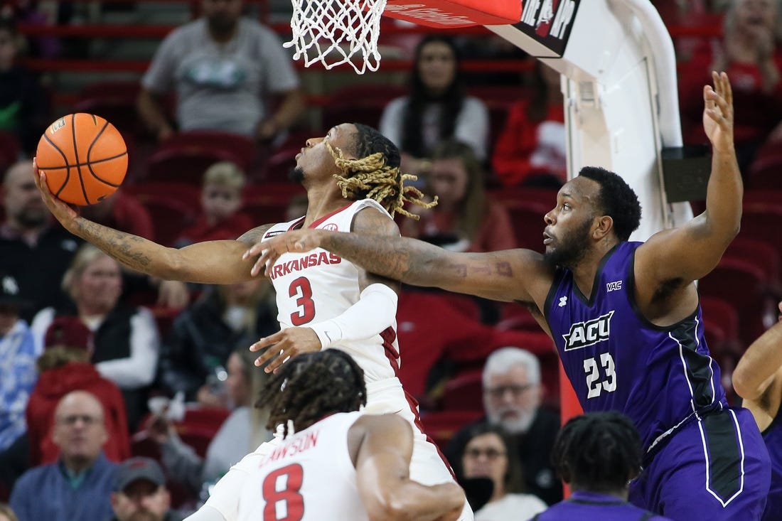 Dec 21, 2023; Fayetteville, Arkansas, USA; Arkansas Razorbacks guard El Ellis (3) shoots as Abilene Christian Wildcats forward Airion Simmons (23) defends during the first half at Bud Walton Arena. Mandatory Credit: Nelson Chenault-USA TODAY Sports