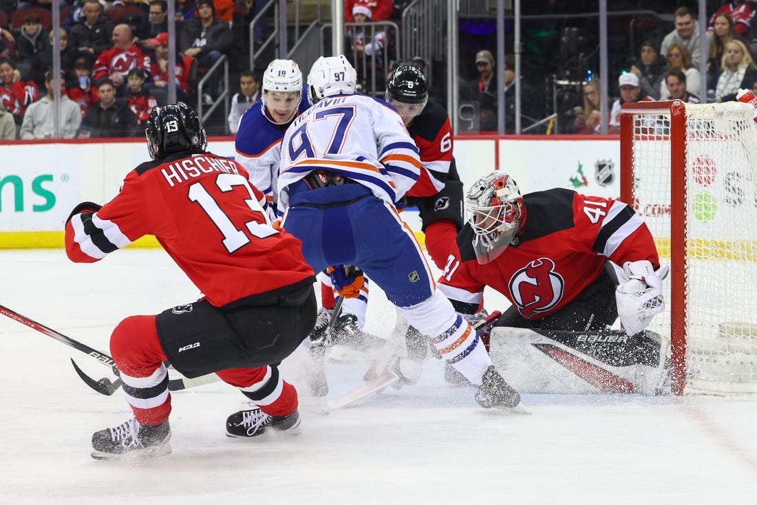 Dec 21, 2023; Newark, New Jersey, USA; New Jersey Devils goaltender Vitek Vanecek (41) makes a save on Edmonton Oilers center Connor McDavid (97) during the first period at Prudential Center. Mandatory Credit: Ed Mulholland-USA TODAY Sports