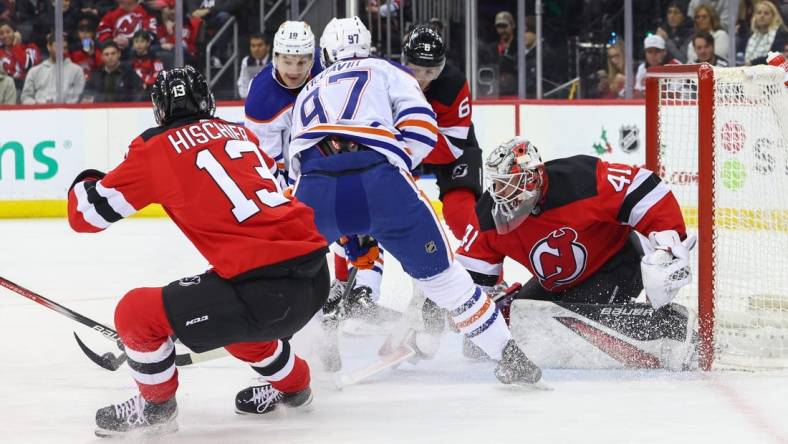 Dec 21, 2023; Newark, New Jersey, USA; New Jersey Devils goaltender Vitek Vanecek (41) makes a save on Edmonton Oilers center Connor McDavid (97) during the first period at Prudential Center. Mandatory Credit: Ed Mulholland-USA TODAY Sports