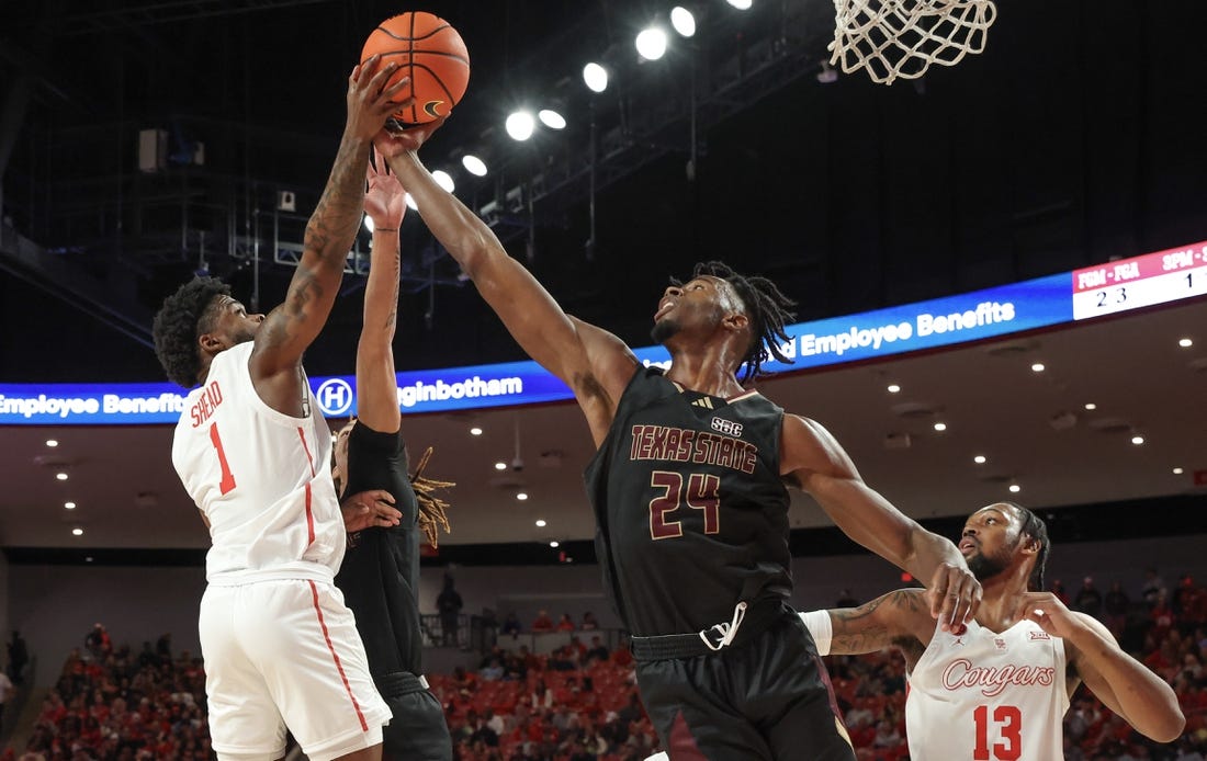 Dec 21, 2023; Houston, Texas, USA; Houston Cougars guard Jamal Shead (1) grabs defensive rebound against Texas State Bobcats forward Brandon Love (24) in the first half at Fertitta Center. Mandatory Credit: Thomas Shea-USA TODAY Sports