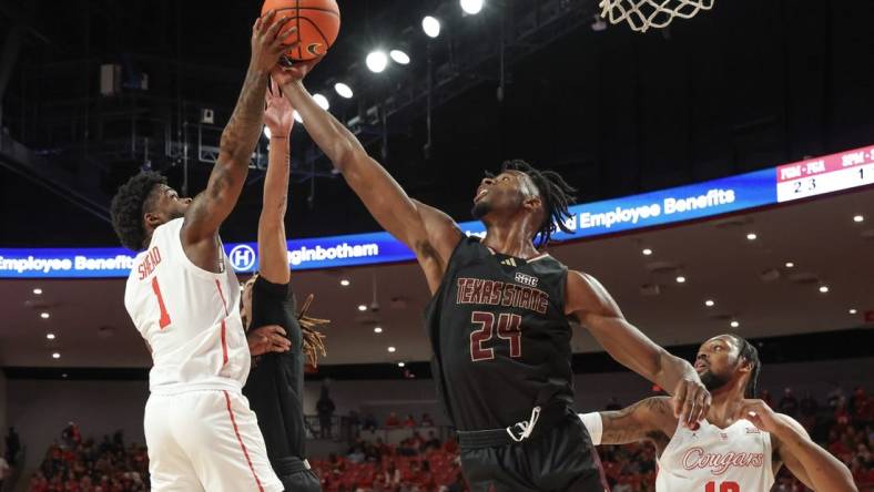 Dec 21, 2023; Houston, Texas, USA; Houston Cougars guard Jamal Shead (1) grabs defensive rebound against Texas State Bobcats forward Brandon Love (24) in the first half at Fertitta Center. Mandatory Credit: Thomas Shea-USA TODAY Sports