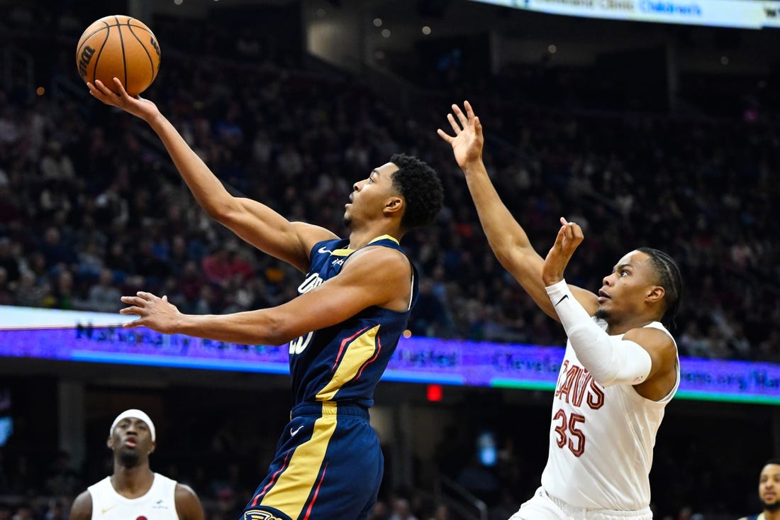 Dec 21, 2023; Cleveland, Ohio, USA; New Orleans Pelicans guard Trey Murphy III (25) drives to the basket beside Cleveland Cavaliers forward Isaac Okoro (35) in the second quarter at Rocket Mortgage FieldHouse. Mandatory Credit: David Richard-USA TODAY Sports