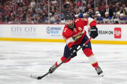 Dec 21, 2023; Sunrise, Florida, USA; Florida Panthers defenseman Aaron Ekblad (5) passes the puck against the St. Louis Blues during the second period at Amerant Bank Arena. Mandatory Credit: Jasen Vinlove-USA TODAY Sports
