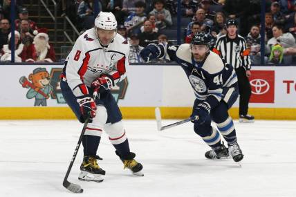 Dec 21, 2023; Columbus, Ohio, USA; Washington Capitals left wing Alex Ovechkin (8) wrists a shot on goal as Columbus Blue Jackets defenseman Erik Gudbranson (44) during the second period at Nationwide Arena. Mandatory Credit: Russell LaBounty-USA TODAY Sports