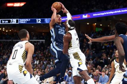 Dec 21, 2023; Memphis, Tennessee, USA; Memphis Grizzlies guard Desmond Bane (22) shoots as Indiana Pacers guard Buddy Hield (7) defends during the first half at FedExForum. Mandatory Credit: Petre Thomas-USA TODAY Sports