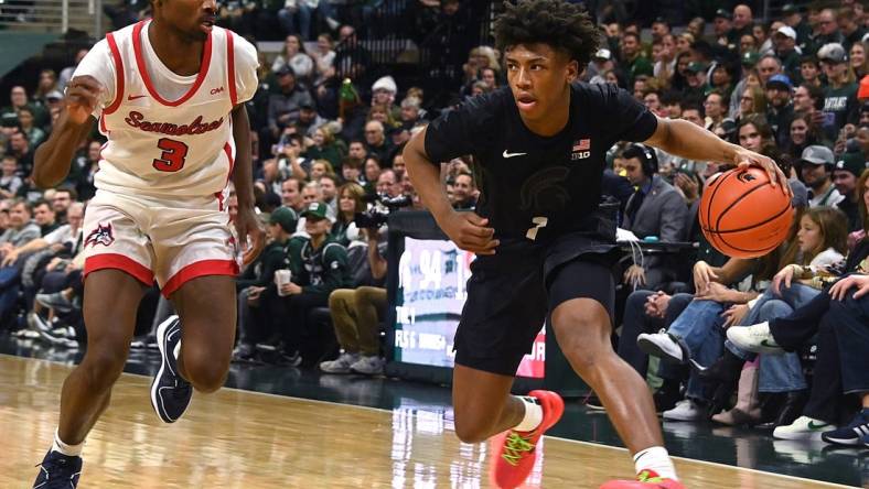 Dec 21, 2023; East Lansing, Michigan, USA; Michigan State Spartans guard Jeremy Fears Jr. (1) drives past Stony Brook Seawolves guard Toby Onyekonwu (3) during the second half at Jack Breslin Student Events Center. Mandatory Credit: Dale Young-USA TODAY Sports