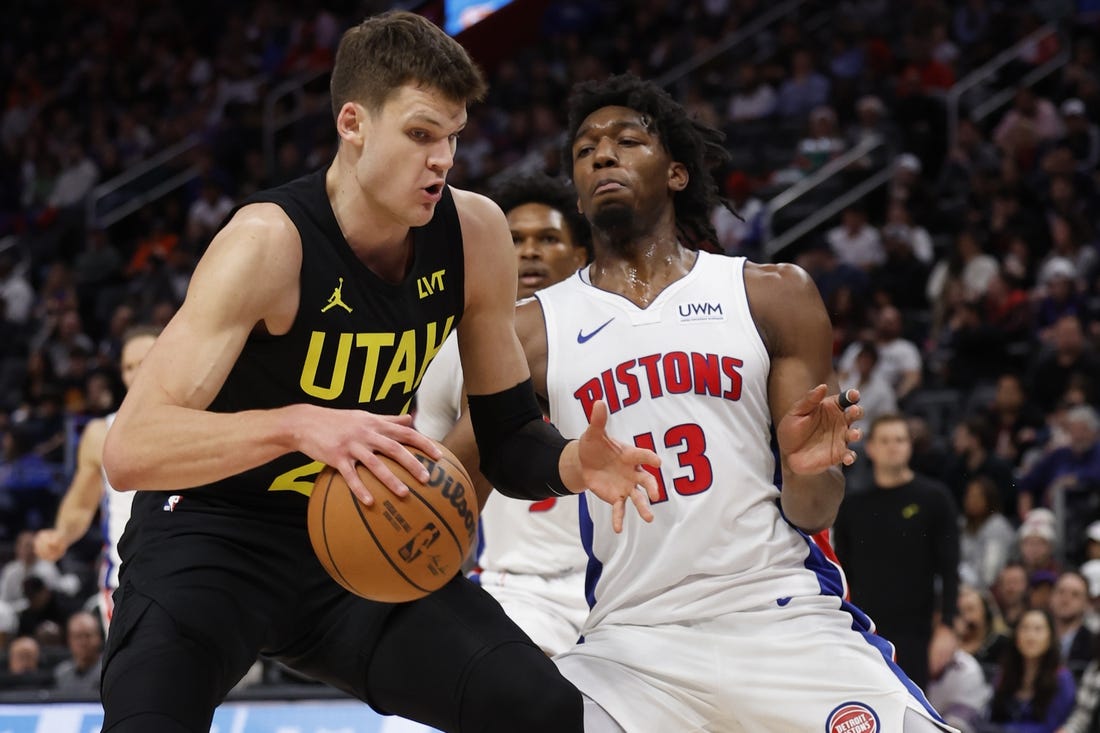 Dec 21, 2023; Detroit, Michigan, USA;  Utah Jazz center Walker Kessler (24) is defended by Detroit Pistons center James Wiseman (13) in the second half at Little Caesars Arena. Mandatory Credit: Rick Osentoski-USA TODAY Sports