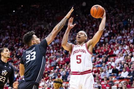 Dec 21, 2023; Bloomington, Indiana, USA; Indiana Hoosiers forward Malik Reneau (5) shoots the ball while North Alabama Lions forward Damian Forrest (33) defends in the first half at Simon Skjodt Assembly Hall. Mandatory Credit: Trevor Ruszkowski-USA TODAY Sports
