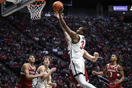 Dec 21, 2023; San Diego, California, USA; San Diego State Aztecs guard Micah Parrish (3) goes to the basket against the Stanford Cardinal during the first half at Viejas Arena. Mandatory Credit: Orlando Ramirez-USA TODAY Sports