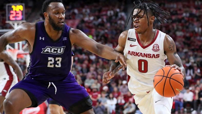 Dec 21, 2023; Fayetteville, Arkansas, USA; Arkansas Razorbacks guard Khalif Battle (0) drives against Abilene Christian Wildcats forward Airion Simmons (23) during the second half at Bud Walton Arena. Arkansas won 83-73. Mandatory Credit: Nelson Chenault-USA TODAY Sports