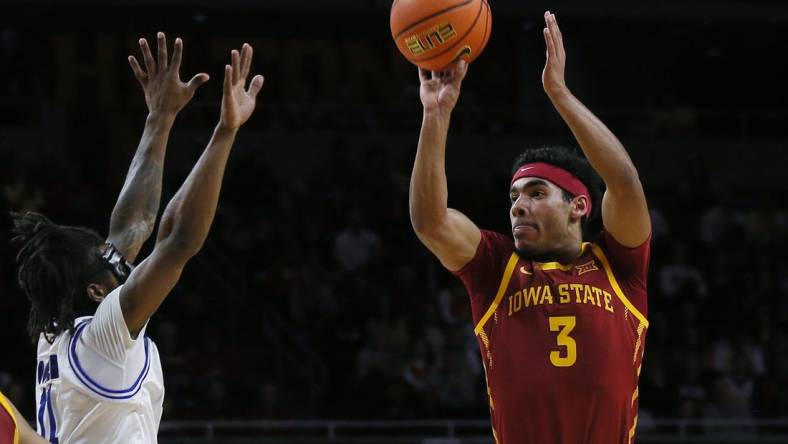 Iowa State Cyclones guard Tamin Lipsey (3) takes athree-pont shot over Eastern Illinois Panthers guard Jordan Booker (11) during the first half of a NCAA college basketball at Hilton Coliseum on Thursday, Dec. 21, 2023, in Ames, Iowa.