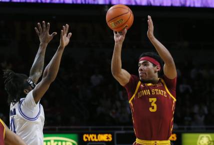 Iowa State Cyclones guard Tamin Lipsey (3) takes athree-pont shot over Eastern Illinois Panthers guard Jordan Booker (11) during the first half of a NCAA college basketball at Hilton Coliseum on Thursday, Dec. 21, 2023, in Ames, Iowa.