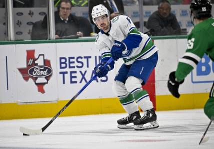 Dec 21, 2023; Dallas, Texas, USA; Vancouver Canucks right wing Conor Garland (8) skates against the Dallas Stars during the third period at the American Airlines Center. Mandatory Credit: Jerome Miron-USA TODAY Sports